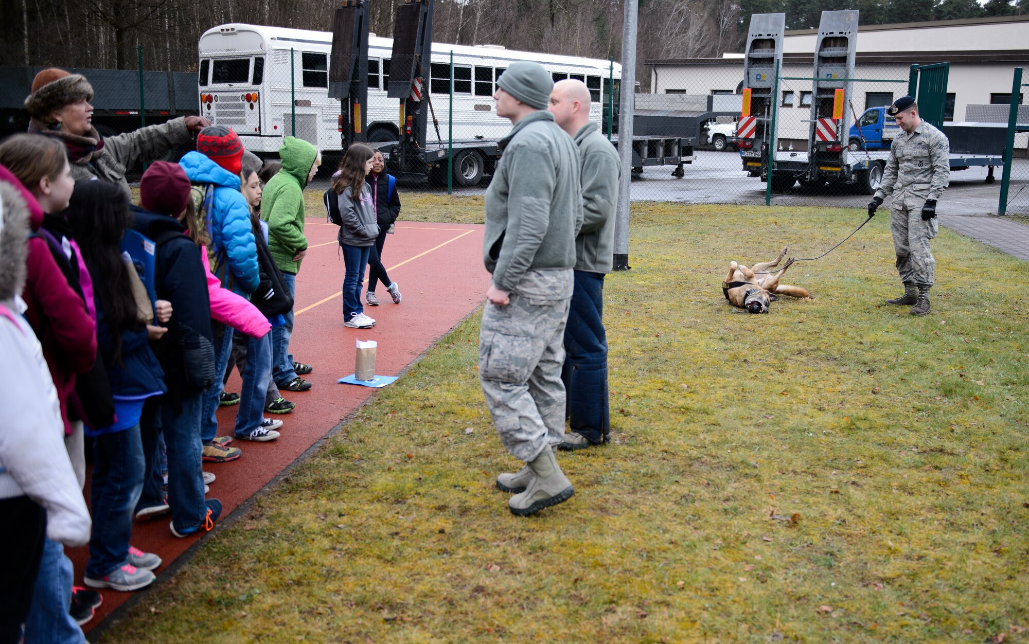 Airmen from the 86th Security Forces showcase a Police K-9 to children at the Intermediate School at Ramstein Air Base, Germany, April 1, 2016. The children underwent a mock deployment to understand the process and events their parents may see during a deployment. (U.S. Air Force photo/Staff Sgt. Armando A. Schwier-Morales)