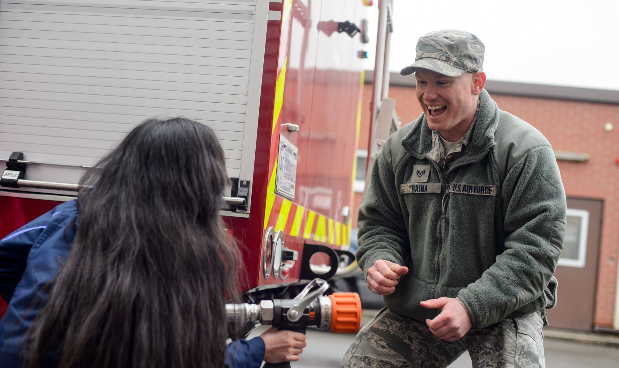 Staff Sgt. Christopher Traina, 435th Construction and Training Squadron fire rescue and contingency training instructor, explains his job to a child going through the 435th CTS mock deployment at Ramstein Air Base, Germany, April 1, 2016. The 435th CTS hosted the mock deployment to show children some of the things their parents may encounter while deployed. (U.S. Air Force photo/Senior Airman Jonathan Stefanko)