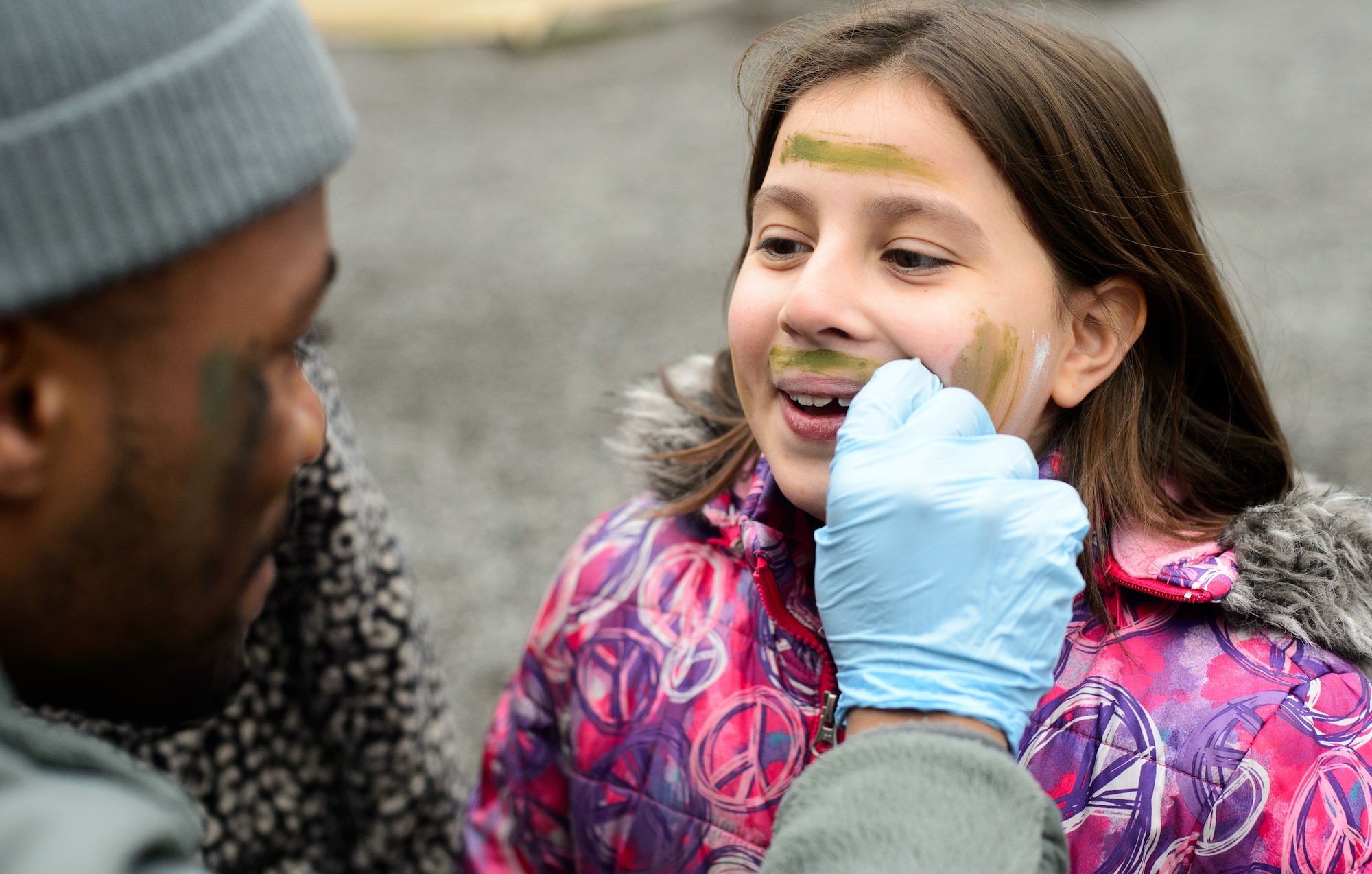 A child from the Ramstein Intermediate School gets her face painted during a mock deployment at Ramstein Air Base, Germany, April 1, 2016. The 435th Construction and Training Squadron and a variety of squadrons around base helped showcase processes Airmen go through before and during a deployment. (U.S. Air Force photo/Senior Airman Jonathan Stefanko)