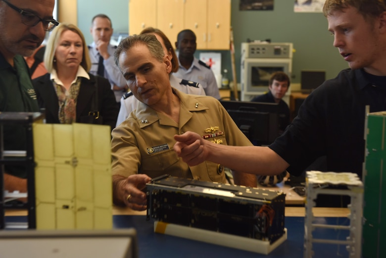U.S. Navy Rear Adm. Brian Brown, deputy commander, Joint Functional Component Command for Space, is shown a CubeSat during a recent visit to California Polytechnic State University, April 1, San Luis Obispo, Calif. During his visit, Brown spoke with members of Cal Poly’s CubeSat program on various topics such as CubeSats, which are satellites made up of mutiples of 10-centimeter cube units, their thoughts on the industry and where it’s headed, and the ongoing partnership between Cal Poly and Vandenberg. (U.S. Air Force photo by Airman 1st Class Robert J. Volio/Released)