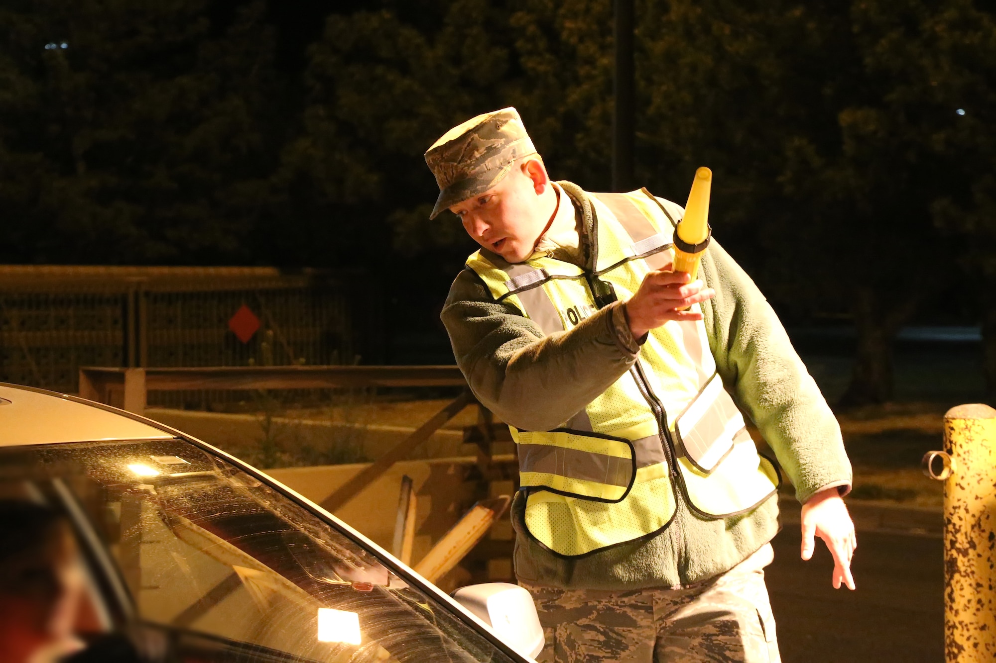 Master Sgt. Michael Rumora, first sergeant with the 58th Maintenance Squadron, uses a flashlight to direct a driver entering the base through Gibson Gate to a random urinalysis site during a gate sweep April 2. The 377th Medical Operations Squadron often conducts gate sweeps during early morning hours to deter military members from using illegal drugs and abusing controlled substances. (U.S. Air Force photo by Master Sgt. Phyllis Keith)
