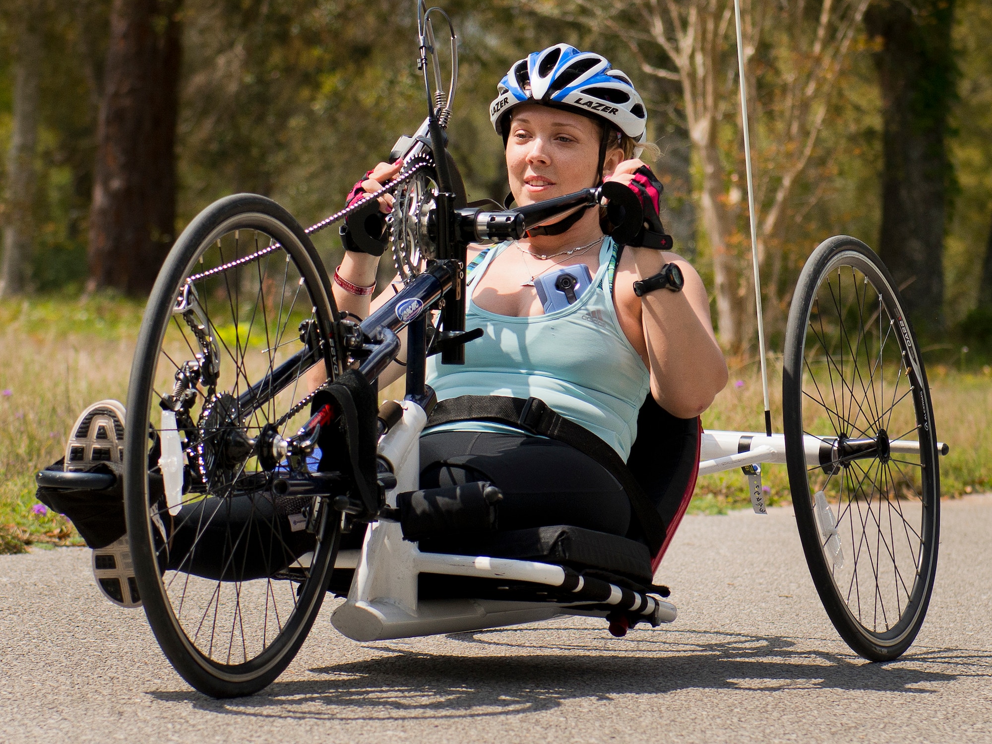 Heather Carter, a Warrior Care attendee, uses a hand-pedaled bike during a morning cycling session at the adaptive sports camp at Eglin Air Force Base, Fla., April 6. The base hosts the week-long Wound Warrior Care event that helps recovering wounded, ill and injured military members through specific hand-on rehabilitative training. (U.S. Air Force photo/Samuel King Jr.)