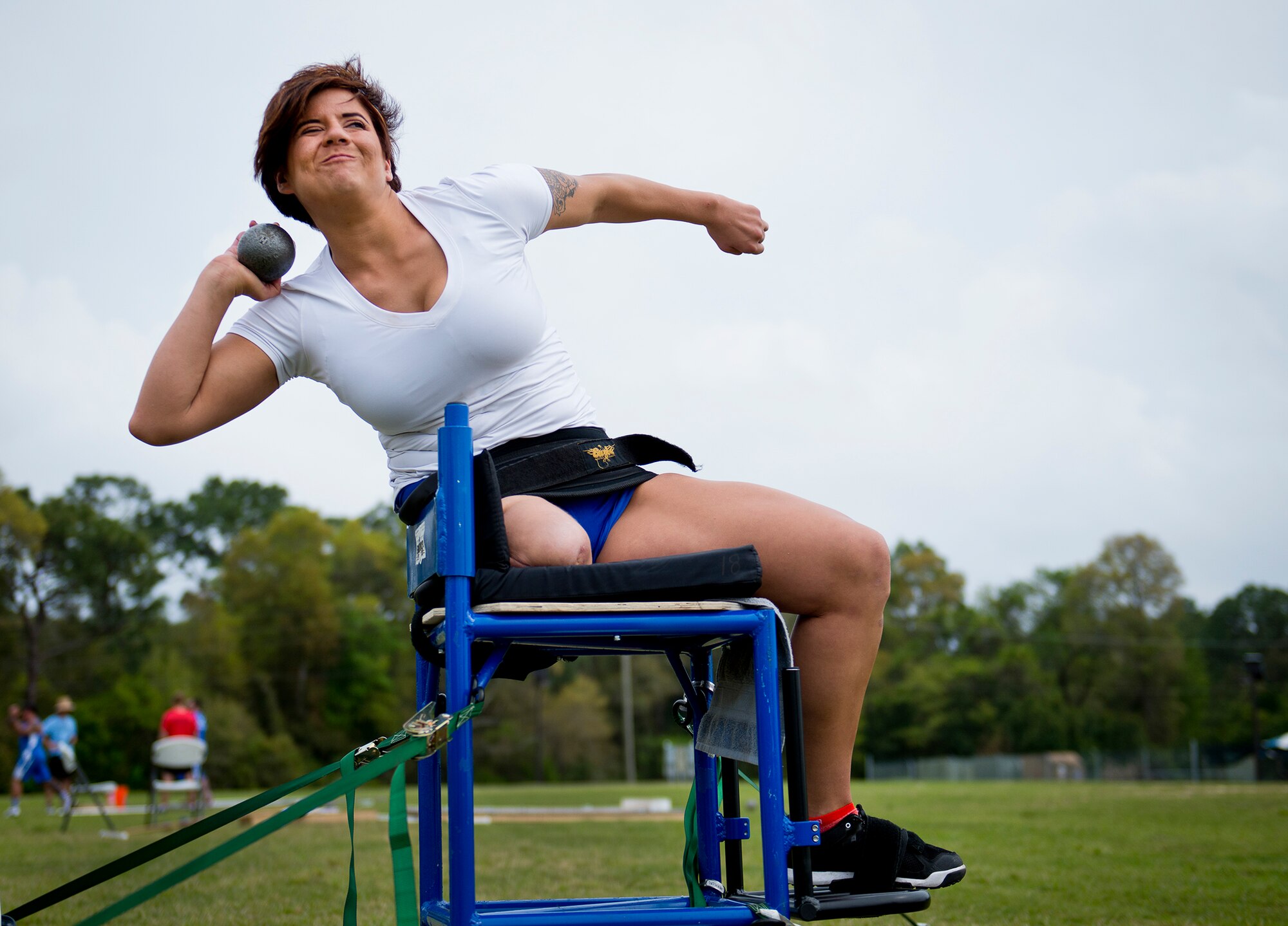 Sebastania Lopez-Arrellano, a Warrior Games and Invictus athlete, winds up for her toss during an afternoon track and field session at the Air Force team’s training camp at Eglin Air Force Base, Fla., April 6.  The base-hosted, week-long Warrior Games training camp is the last team practice session before the yearly competition in June.  (U.S. Air Force photo/Samuel King Jr.)
