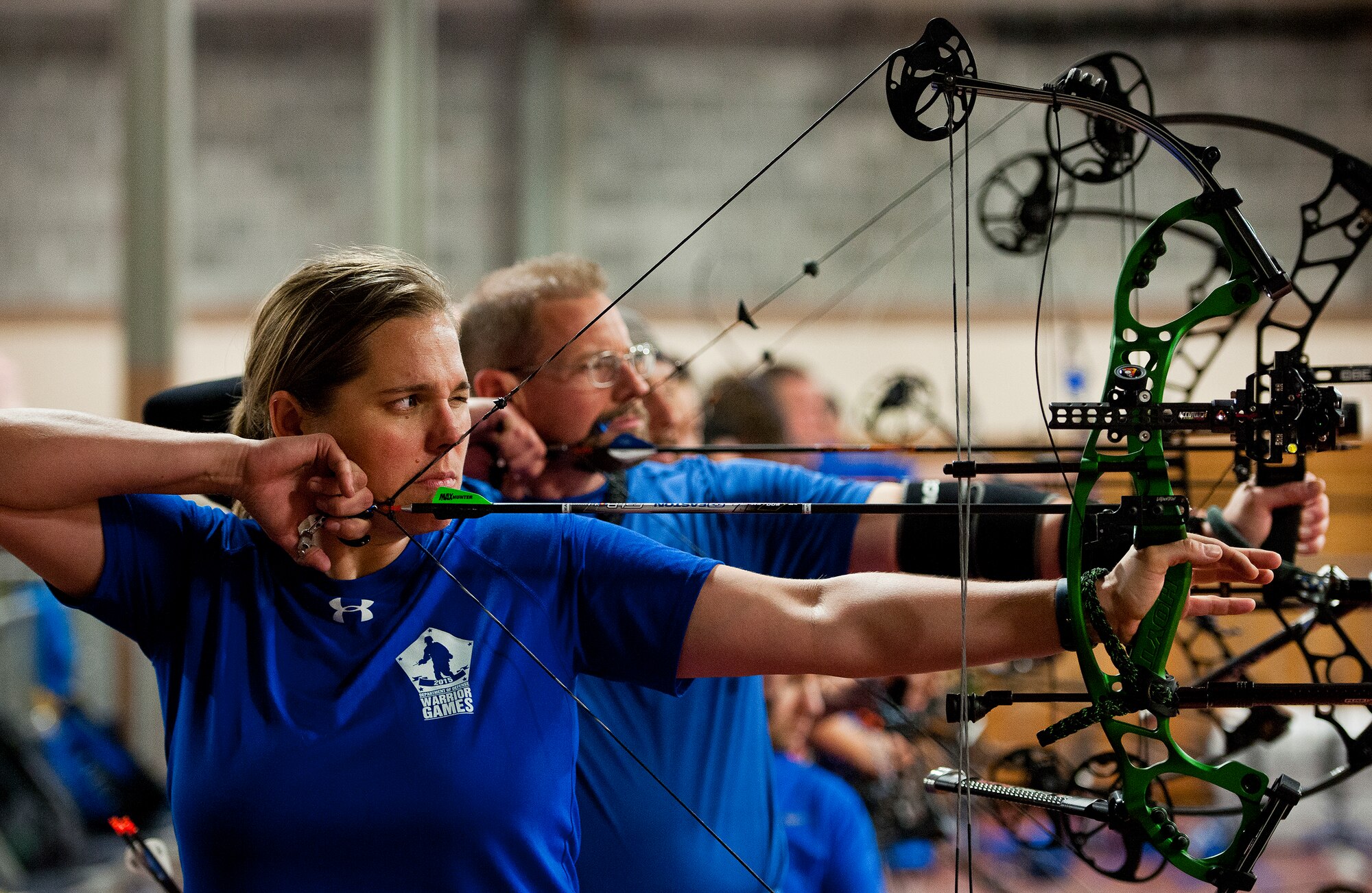 Kyle Burnett, a Warrior Games athlete, stretches back her bow during an afternoon archery session at the Air Force team’s training camp at Eglin Air Force Base, Fla., April 6.  The base-hosted, week-long Warrior Games training camp is the last team practice session before the yearly competition in June.  (U.S. Air Force photo/Samuel King Jr.)