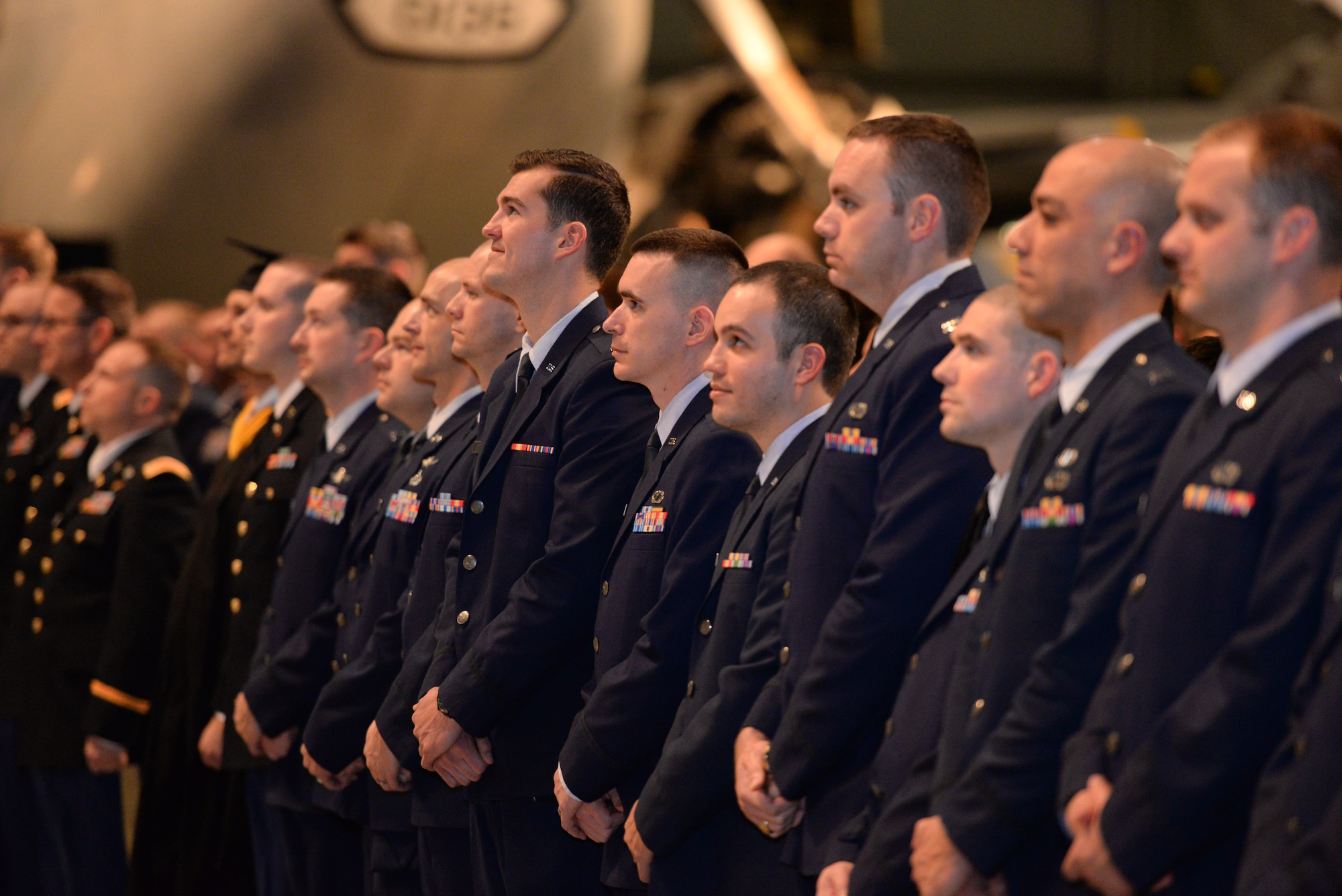 Graduates stand in formation during the Air Force Institute of Technology Commencement Ceremony March 24, 2016 at the National Museum of United States Air Force. AFIT is focused on providing exceptional defense-focused research-based graduate education. (U.S. Air Force photo by Michelle Gigante)