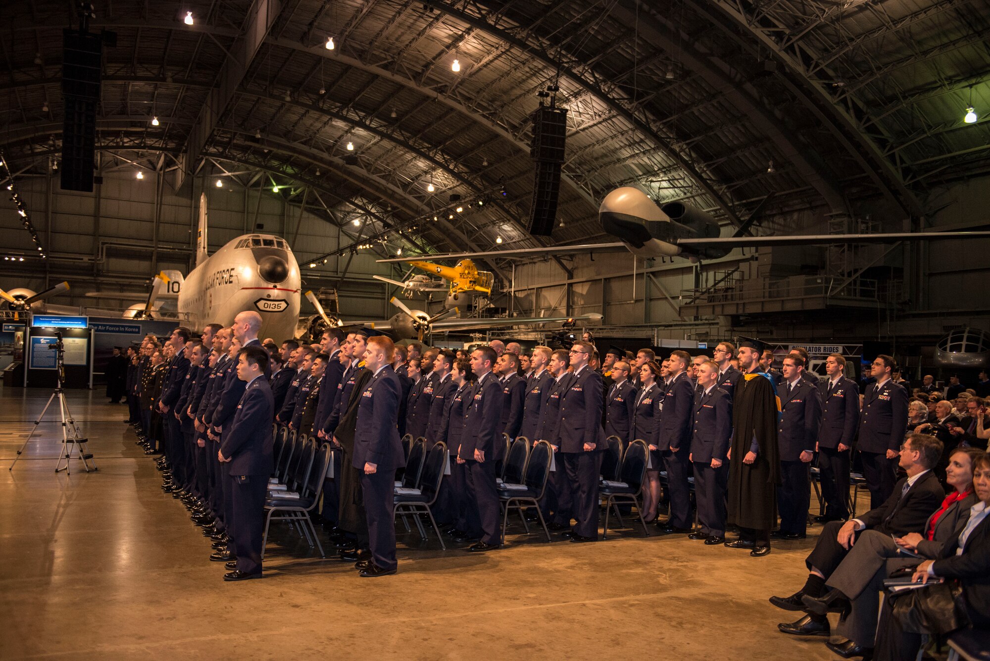 Graduates stand in formation during the Air Force Institute of Technology Commencement Ceremony March 24, 2016 at the National Museum of United States Air Force. AFIT is focused on providing exceptional defense-focused research-based graduate education. (U.S. Air Force photo by Michelle Gigante)