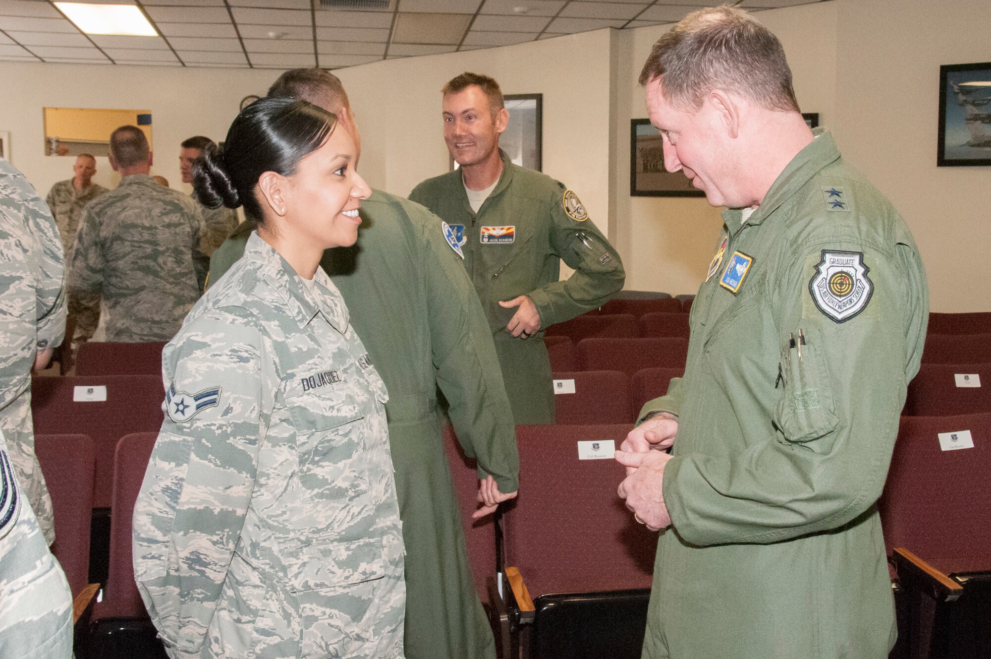 Maj. Gen. James Hecker, 19th Air Force commander, speaks with Airman 1st Class Irlanda Dojaquez from the Arizona Air National Guard’s 162nd Wing during his visit March 30-April 1 to the Tucson International Airport.  The general met with members of the 162nd Wing, whose mission is to train fighter pilots from around the world.  (U.S. Air National Guard photo by 2nd Lt. Lacey Roberts/Released)
