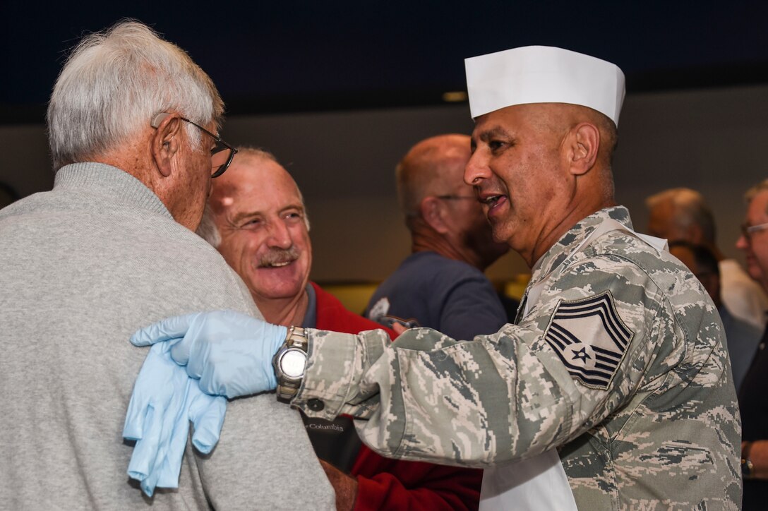 U.S. Air Force Chief Master Sgt. Johnny Leal, 144th Logistics Readiness Squadron, talks with retirees from the 144th FW during a retiree breakfast at the Fresno Air National Guard Base April 7, 2016. The breakfast, which takes place once every year, gives the retirees an opportunity to reunite and meet with current members of the 144th FW. (U.S. Air National Guard photo by Senior Airman Klynne Pearl Serrano)