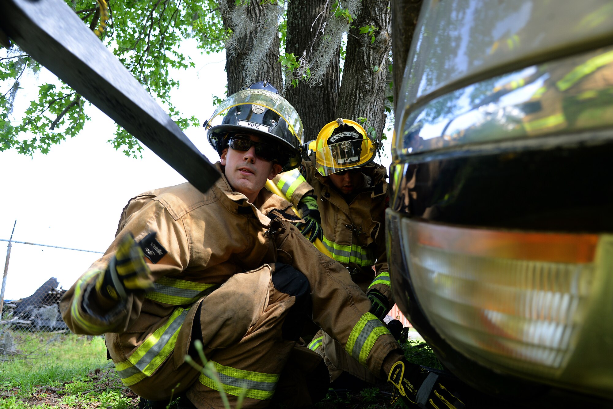 A picture of Airman 1st Class Scott Bramhall of the 177th Fighter Wing Fire Department, New Jersey Air National Guard, utilizing wedge cribbing to stabilize a vehicle.