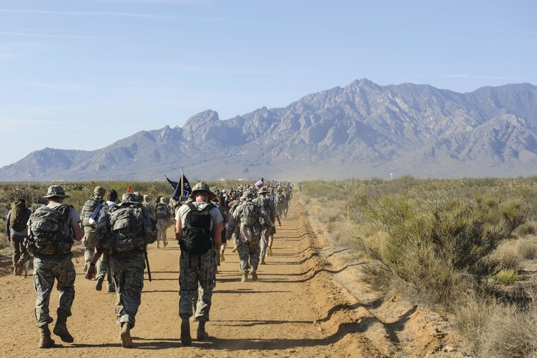 Airmen, carrying 35-pound rucksacks, participate in the 2016 Bataan Memorial Death March with 6,600 other participants March 20 at White Sands Missile Range. The 27th annual march was 26.2 miles long and served as a reminder for today’s generation of the harsh conditions World War II prisoners of war endured during the 60-mile Bataan Death March to a prisoner-of-war camp in the Philippines. (U.S. Air Force photo by Senior Airman Harry Brexel)
