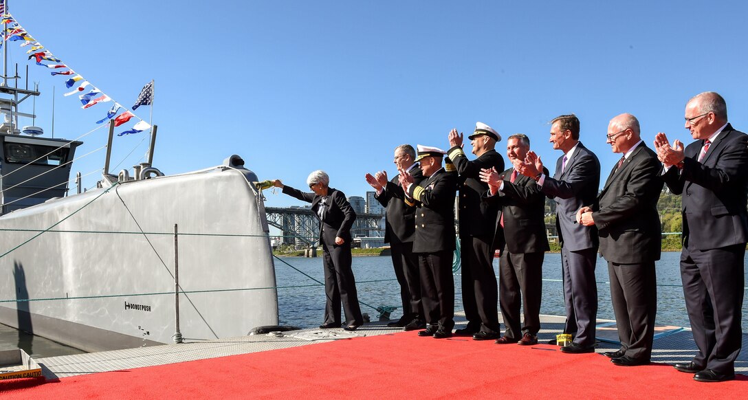 Deputy Defense Secretary Bob Work, second from left, celebrates during a Defense Advanced Research Projects Agency christening ceremony for a technology demonstration vessel in Portland, Ore., April 7, 2016. DARPA’s anti-submarine warfare continuous trail unmanned vessel, or ACTUV, program, designed, developed and built the vessel. DoD photo by Army Sgt. 1st Class Clydell Kinchen