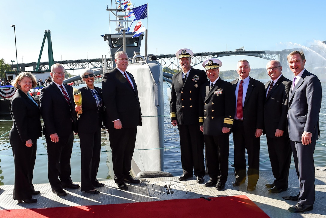 Deputy Defense Secretary Bob Work, center left, poses for a photograph after a Defense Advanced Research Projects Agency christening ceremony for a technology demonstration vessel in Portland, Ore., April 7, 2016. DoD photo by Army Sgt. 1st Class Clydell Kinchen