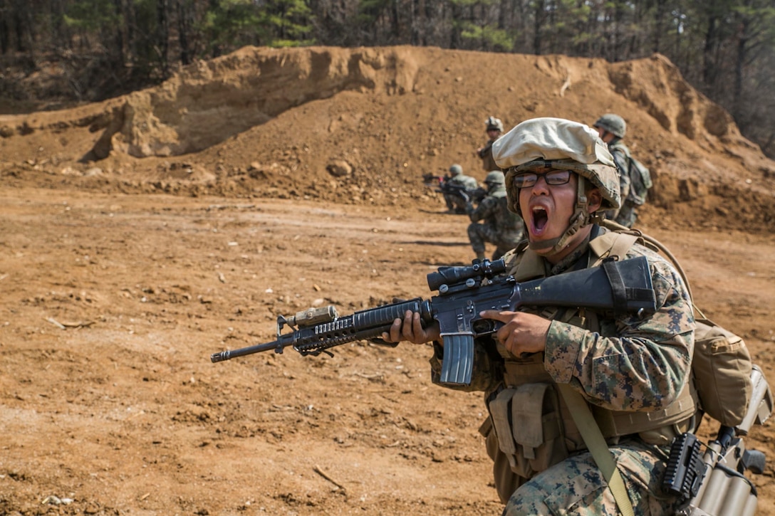 CAMP RODRIGUEZ, South Korea — U.S. Marine Cpl. Edilberto Olguin shouts out a command while executing a live fire and maneuver exercise on Camp Rodriguez, South Korea,  as a part of Korean Marine Exchange Program 16-R April 7, 2016. KMEP is a bilateral exercise that gives ROK Marines and U.S. Marines the opportunity to train side-by-side and help improve the relationship between the two nations. The ROK Marines are with 1st ROK Marine Division. Olguin from Labelle, Florida, is a combat engineer with 9th Engineer Support Battalion, 3rd Marine Logistics Group, III Marine Expeditionary Force. (U.S. Marine Corps photo by Cpl. Ryan C. Mains/ Released)