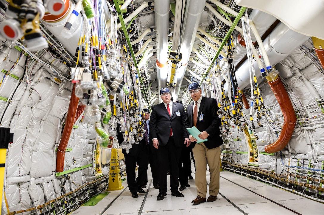 Deputy Defense Secretary Bob Work, left, tours the P-8 specific final installation bay and the P-8 in Renton, Wash., April 7, 2016. The P-8A Poseidon aircraft, derived from the next-generation 737-800, is designed for long-range anti-submarine warfare, anti-surface warfare and intelligence, surveillance and reconnaissance missions. DoD photo by Army Sgt. 1st Class Clydell Kinchen