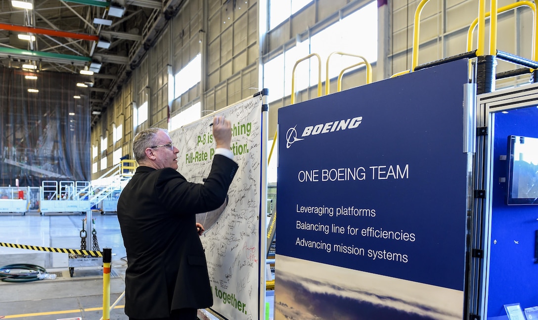 Deputy Defense Secretary Bob Work signs a canvas at the P-8 specific final installation bay in Renton, Wash., April 7, 2016. DoD photo by Army Sgt. 1st Class Clydell Kinchen