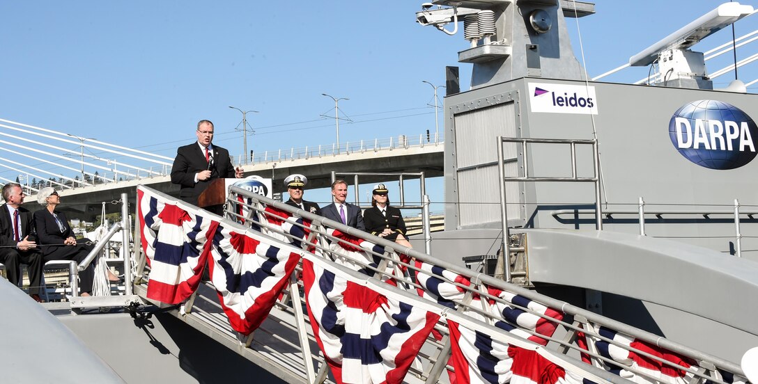 Deputy Defense Secretary Bob Work delivers remarks during a Defense Advanced Research Projects Agency christening ceremony for a technology demonstration vessel in Portland, Ore., April 7, 2016. DARPA’s anti-submarine warfare continuous trail unmanned vessel, or ACTUV, program, designed, developed and built the vessel. DoD photo by Army Sgt. 1st Class Clydell Kinchen