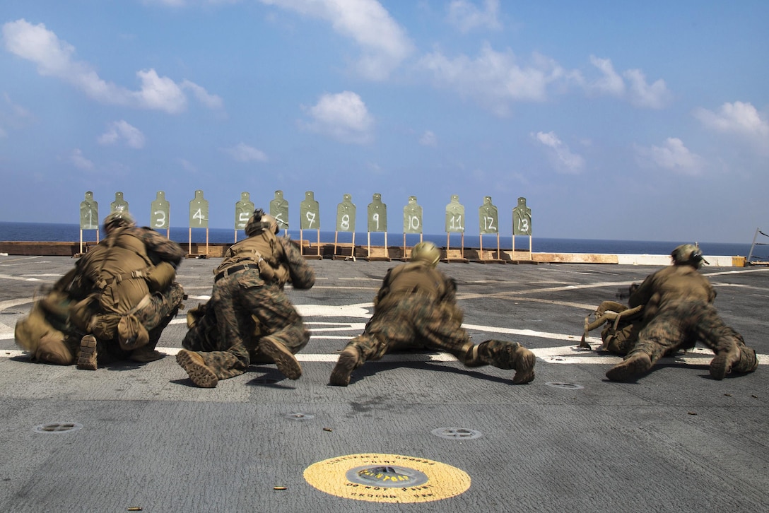 Marines prepare to fire their weapons during a deck shoot aboard the USS New Orleans in the Pacific Ocean, April 1, 2016. Marine Corps photo by Sgt. Hector de Jesus
