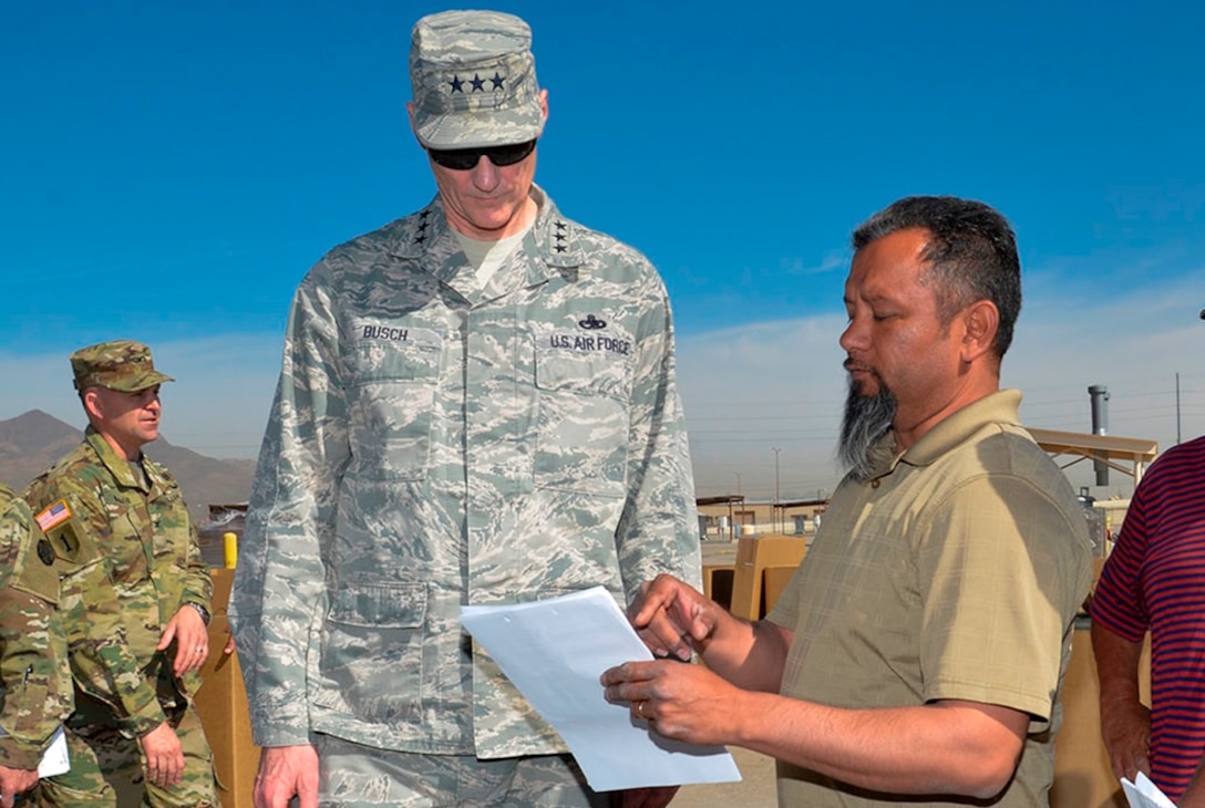 Francisco Alvarez, a DLA Disposition Services property disposal specialist, briefs DLA Director Air Force Lt. Gen. Andy Busch on the progress of the divestiture of Army property over to DLA Distribution and DLA Disposition Services during his April 5 visit to Fort Bliss, Texas.
