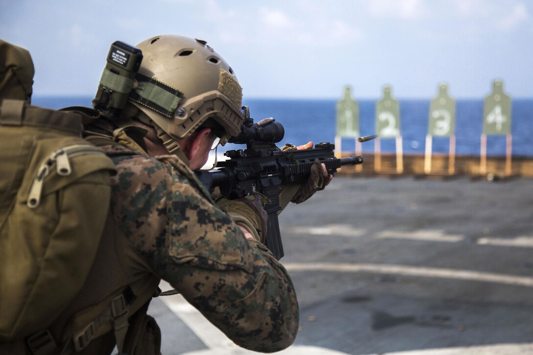 A Marine fires a weapon during a deck shoot aboard the USS New Orleans in the Pacific Ocean, April 1, 2016. Marine Corps photo by Sgt. Hector de Jesus