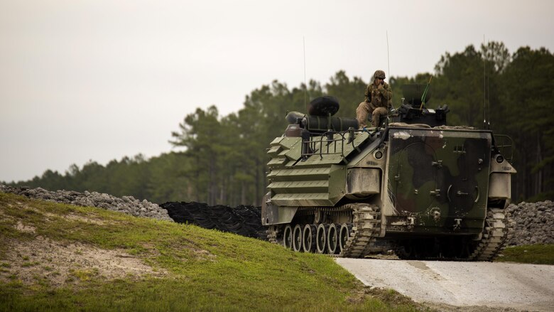 Cpl. Trevor Dodson, a vehicle commander with 2nd Assault Amphibian Battalion, communicates with range control to begin qualifying with an Amphibious Assault Vehicle during Heavy Brigade Combat Team training at Marine Corps Base Camp Lejeune, North Carolina, April 5, 2016. The unit conducts this type of training semi-annually to ensure all their Marines meet the requirements to successfully engage the enemy in a deployed environment.