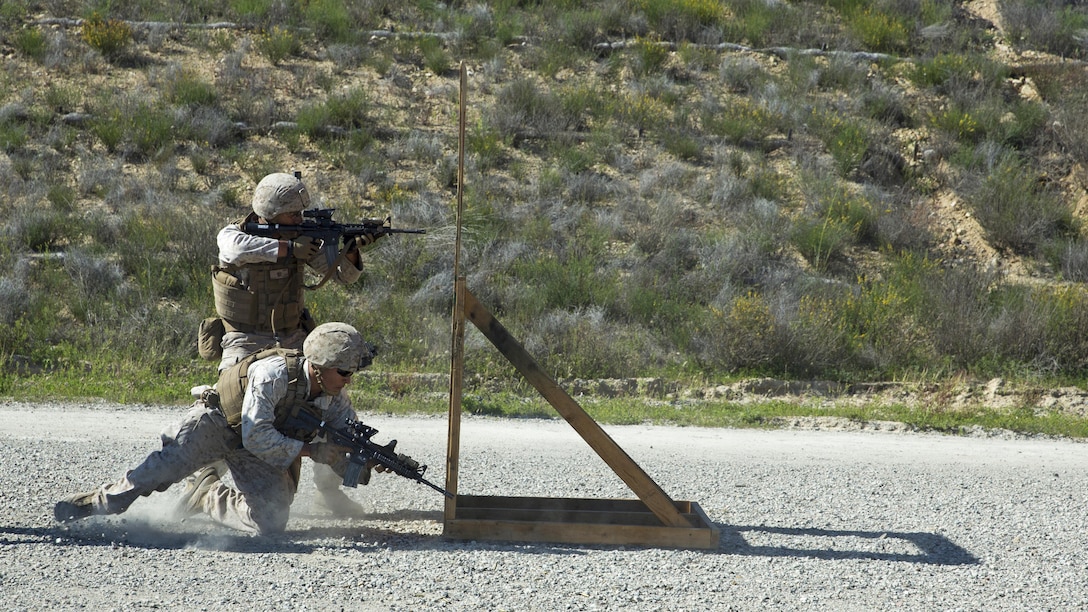 Cpl. Nathaniel Asoau, Light Armored Vehicle crewman with Company D., 1st Light Armored Reconnaissance Battalion and student with the Urban Leaders Course, provides covering fire from behind a barricade while his partner, Lance Cpl. Leonardo Perez, drops to a prone position during a combat marksmanship program range at Marine Corps Base Camp Pendleton, California, March 31, 2016. This range is the first live-fire range of the three-week course and is designed to hone Marines’ combat marksmanship skills including how to shoot, move and communicate with a buddy. 