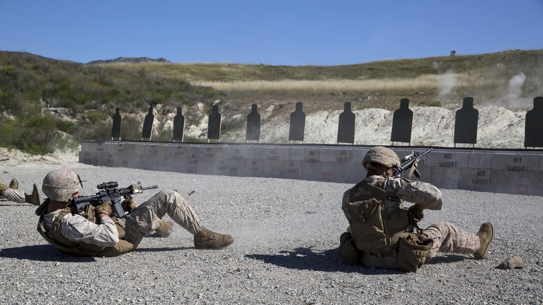 Cpl. Richard Nedlic (Right), Light Armored Vehicle crewman and Cpl. Nicholas Guiles, rifleman, both with 1st Light Armored Reconnaissance Battalion and students in the Urban Leaders Course, fire their weapons from the supine position during a combat marksmanship program range at Marine Corps Base Camp Pendleton, California, March 31, 2016. This firing drill is meant to train Marines to safely and accurately return fire if they fall backward while moving or are knocked down.