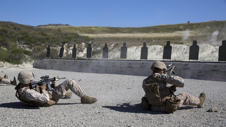 Cpl. Richard Nedlic (Right), Light Armored Vehicle crewman and Cpl. Nicholas Guiles, rifleman, both with 1st Light Armored Reconnaissance Battalion and students in the Urban Leaders Course, fire their weapons from the supine position during a combat marksmanship program range at Marine Corps Base Camp Pendleton, California, March 31, 2016. This firing drill is meant to train Marines to safely and accurately return fire if they fall backward while moving or are knocked down.