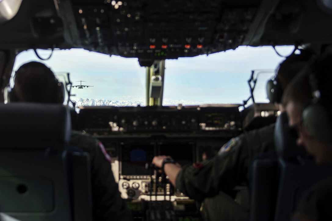 Air Force C-17 Globemaster III aircraft fly in formation during Large Package Week at Joint Base Elmendorf-Richardson, Alaska, April 5, 2016. Air Force photo by Senior Airman James Richardson
