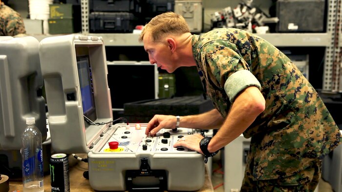 An explosive ordnance disposal technician with 9th Engineer Support Battalion, 3rd Marine Logistics Group, III Marine Expeditionary Force, gets hands-on experience with the Remote Fuse Disassembly System at Camp Hansen, Okinawa, Japan, April 8, 2016. The system was designed to make explosive ordnance disposal safer.
