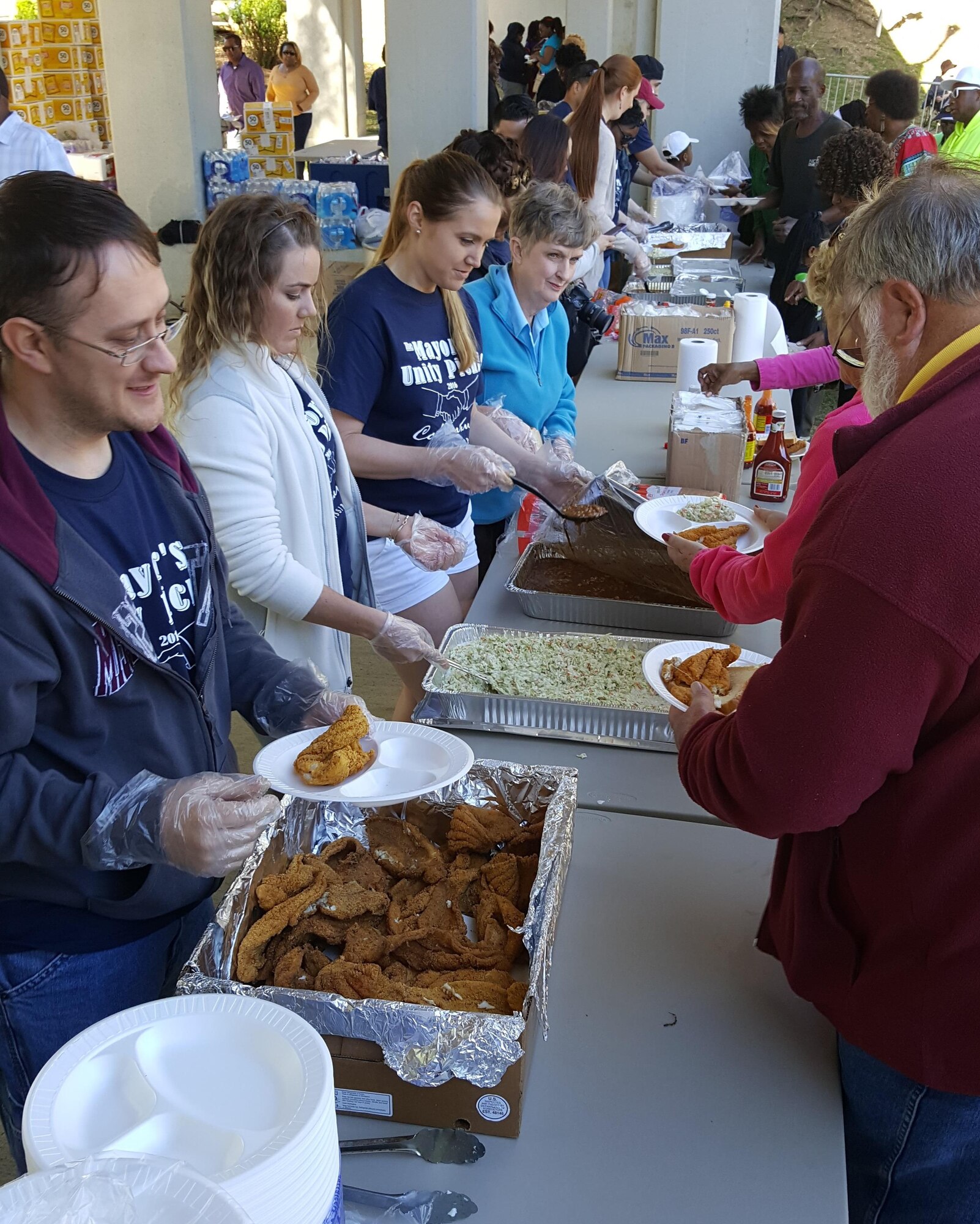 Airmen from Columbus Air Force Base serve fried catfish meals to members of the community April 2 at the Mayor’s Unity Picnic. Over 1,000 pounds of catfish was served to over 2,000 attendees. (Courtesy photo/Vanessa Brown)