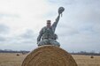 U.S. Army Reserve  Sgt. Joe Villines, with the 203rd Public Affairs Detachment, poses for a picture highlighting the cross between two of his work worlds at Camp Dodge, Iowa, March 18, 2016. Villines manages to find the balance between his military obligations, his civilian career with the Department of Veterans affairs, fatherhood, and a growing passion in rural farming. Joe is increasing his knowledge on traditional farming and becoming a man of the soil, and in the process giving back to his local community.(U.S. Army Reserve photo by  Brian Godette, USARC Public Affairs)