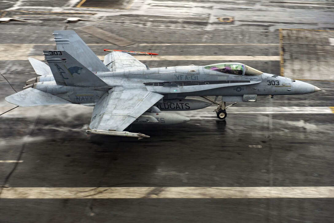 An F/A-18C Hornet makes an arrested landing on the flight deck of the aircraft carrier USS Dwight D. Eisenhower in the Atlantic Ocean, March 31, 2016. The Eisenhower is underway conducting a composite training unit exercise in preparation for a future deployment. Navy photo by Specialist Seaman Casey J. Hopkins