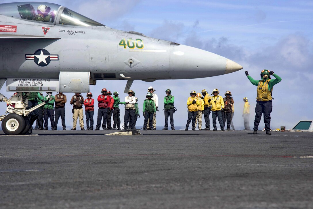 An F/A-18E Super Hornet undergoes preflight checks on the flight deck of the aircraft carrier USS Dwight D. Eisenhower in the Atlantic Ocean, March 31, 2016. Navy photo by Petty Officer 3rd Class Anderson W. Branch