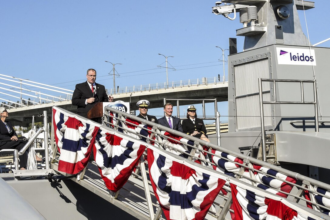 Deputy Defense Secretary Bob Work delivers remarks during a Defense Advanced Research Projects Agency christening ceremony for a technology demonstration vessel in Portland, Ore., April 7, 2016. DARPA’s anti-submarine warfare continuous trail unmanned vessel program designed, developed and built the vessel. DoD photo by Army Sgt. 1st Class Clydell Kinchen