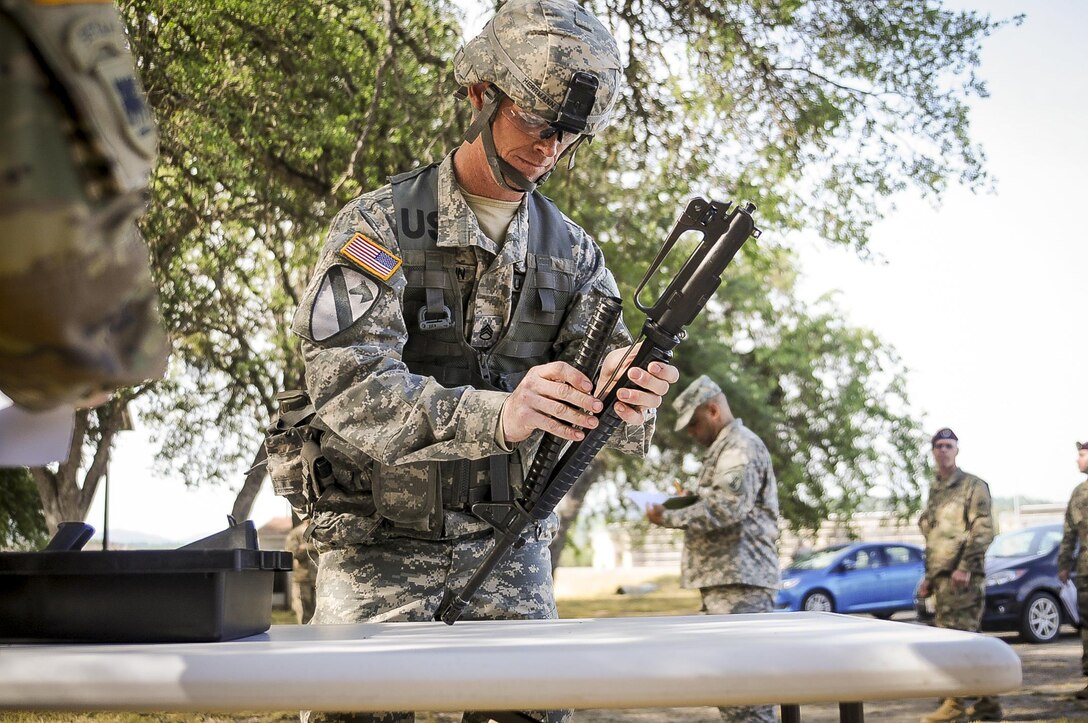 Staff Sgt. Alex Herrmann, a civil affairs specialist from Amarillo, Texas, representing the 350th Civil Affairs Command, competes in the weapons assembly mystery event at the U.S. Army Civil Affairs and Psychological Operations Command 2016 U.S. Army Best Warrior Competition at Fort Hunter Liggett, Calif., April 6, 2016. This year’s Best Warrior competition will determine the top noncommissioned officer and junior enlisted Soldier who will represent USACAPOC in the Army Reserve Best Warrior competition later this year. (U.S. Army photo by Spc. Khadijah Lutz-Wilcox, USACAPOC)