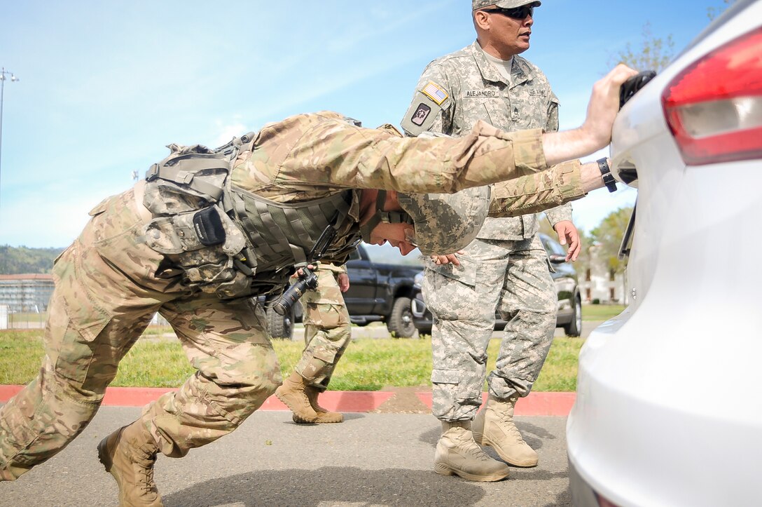 Sgt. Maxwell Buchanan-McGrath, a psychological operations specialist from Bradenton, Fla., representing the 2nd Psychological Operations Group,  competes in mystery event pushing a vehicle at the U.S. Army Civil Affairs and Psychological Operations Command 2016 U.S. Army Best Warrior Competition at Fort Hunter Liggett, Calif., April 6, 2016. This year’s Best Warrior competition will determine the top noncommissioned officer and junior enlisted Soldier who will represent USACAPOC in the Army Reserve Best Warrior competition later this year. (U.S. Army photo by Spc. Khadijah Lutz-Wilcox, USACAPOC)