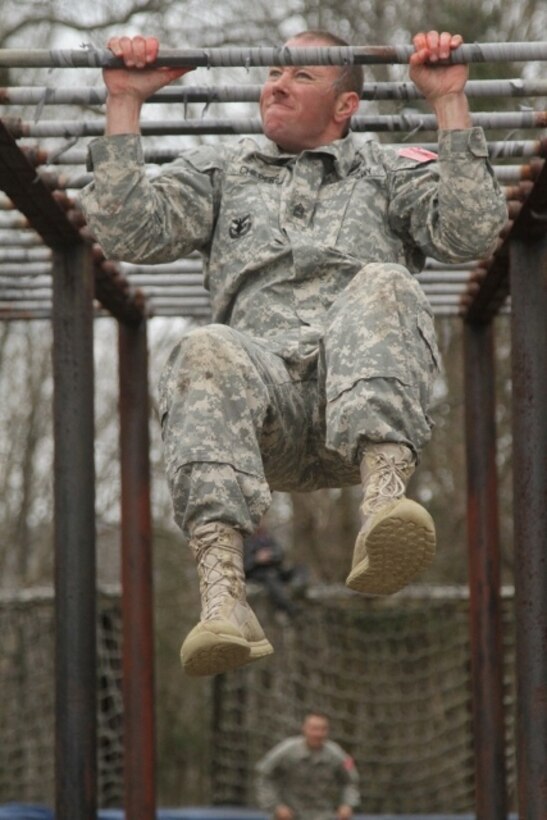 U.S. Army Sgt. 1st Class Jeremy Childers, assigned to Army Reserve Careers Division, does a pull up after completing the Obstacle Course event during the joint Best Warrior Competition hosted by 84th Reserve Training Command at Ft. Knox, Ky., March 23, 2016. The Best Warrior Competition is a four-day competition that tests competitors' Army aptitude by going through urban warfare situations, board interviews, physical fitness tests, written exams, Warrior tasks and battle drills relevant to today's operational environment. (U.S. Army photo by Spc. Josephine Carlson/Released)