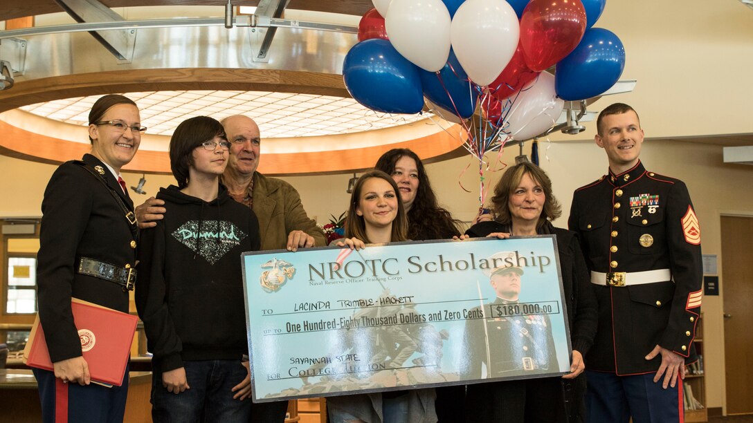 Lacinda Trimble-Hackett (center) is awarded the Naval Reserve Officer Training Corps scholarship at the library of Catskill Senior High School by U.S. Marine Corps Capt. Carolyn Giebel (left) and Gunnery Sgt. Brian Buckwalter (right) the morning of April 5, 2016. Hackett was among the three out of 32 applicants who were accepted for the scholarship and applied through Marine Corps Recruiting Station Albany, N.Y., whom Giebel and Buckwalter represent.