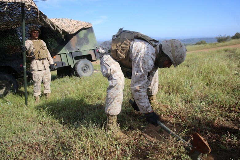 MARINE CORPS BASE CAMP PENDLETON, Calif. - Marines with Battery Q, 5th Battalion, 11th Marine Regiment, I Marine Expeditionary Force, set up camouflage netting during Spring Fire Exercise at Camp Pendleton March 31, 2016. During the combined-arms training evolution, each battalion moved to different locations on a frequent basis in order to simulate positions they would hold based on specific situations, setting up and breaking down their outposts as quickly as possible. (U.S. Marine Corps Photo by Cpl. Demetrius Morgan/ RELEASED)