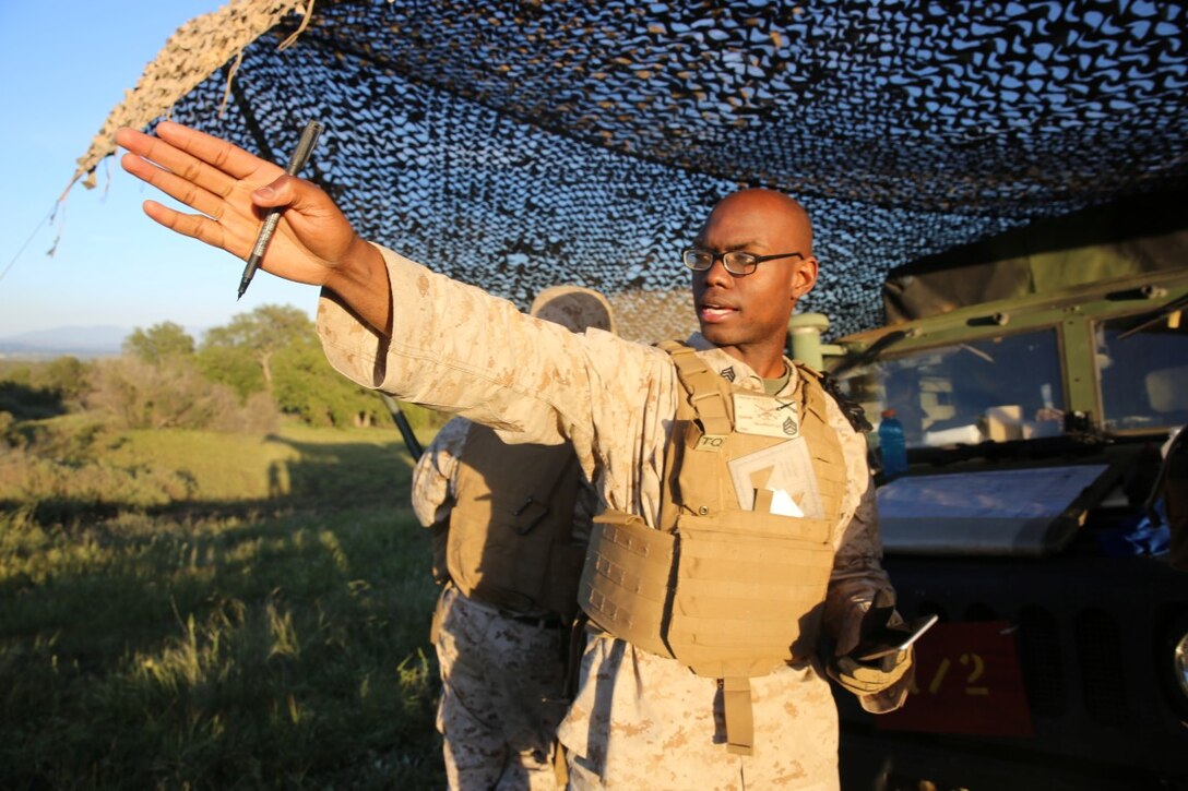 MARINE CORPS BASE CAMP PENDLETON, Calif. - Staff Sgt. Albert Macklin, a battery local security chief with Battery Q, 5th Battalion, 11th Marine Regiment, I Marine Expeditionary Force and New Orleans native, helps coordinate 360-degree security during Spring Fire Exercise at Camp Pendleton March 31, 2016. During the combined-arms training exercise, Macklin and other Marines helped coordinate where all security posts were, along with securing the various parts of the range in accordance with where the battery was firing. (U.S. Marine Corps Photo by Cpl. Demetrius Morgan/RELEASED)