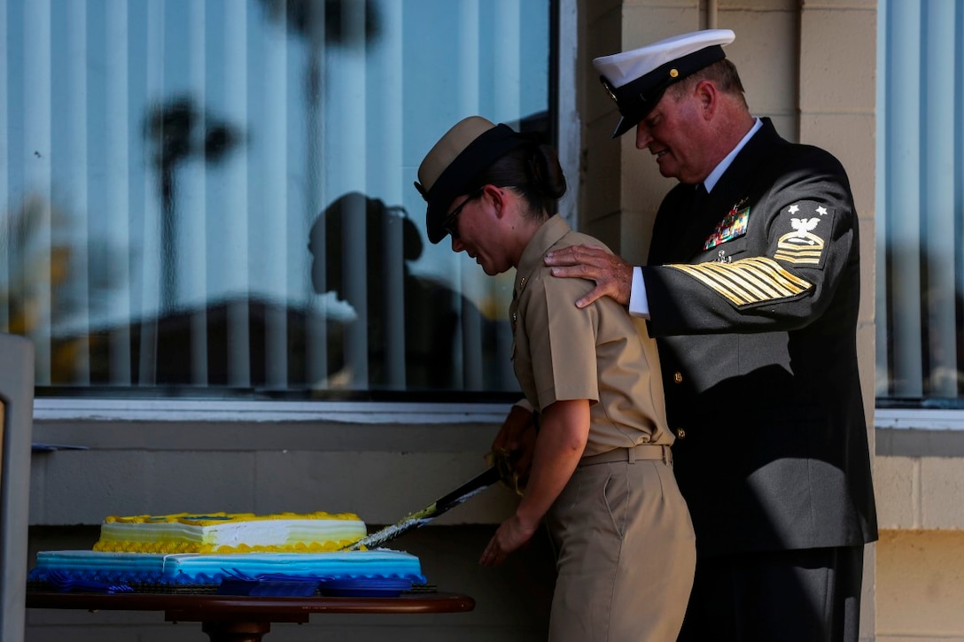 MARINE CORPS BASE CAMP PENDLETON, Calif. – Chief Petty Officer Soniya Stoddard, left, a chief hospital corpsman with 1st Medical Battalion, 1st Marine Logistics Group, and (ret.) Master Chief Petty Officer Thomas Dye, right, cut a birthday cake as part of a dedication ceremony of Camp Pendleton’s ‘Anchor Up Club’ as a Chiefs Mess to the North County Chief Petty Officer Association on April 1, 2016, at Camp Pendleton. Marines with I Marine Expeditionary Force Headquarters Group dedicated the club in celebration of the 123rd birthday of chief petty officers throughout the Navy. A Chiefs Mess is a lounge and living quarters area typically designated for chief petty officers aboard boats, ships, and Naval Air Stations. (U.S. Marine Corps photo by Cpl. Angel Serna/Released)