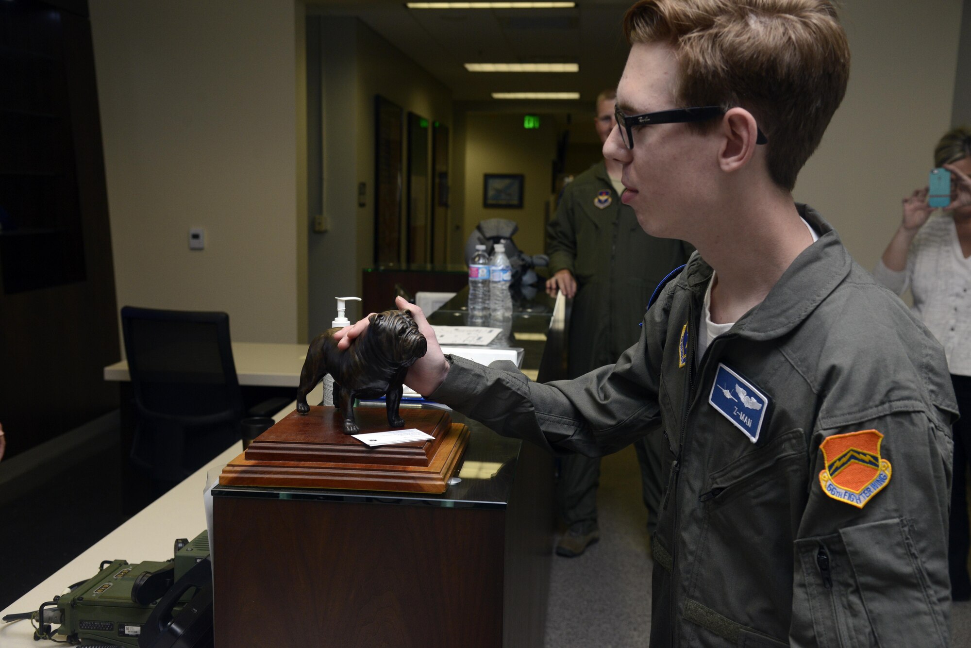 Zach "Z-man" Anderson, 16, touches the 62nd Fighter Squadron mascot during his visit to the squadron at Luke Air Force Base, Ariz., April 7, 2016. Anderson received the tour as part of the pilot for a day program, which provides children who have serious or chronic illnesses an opportunity to be part of a flying squadron for an entire day. (U.S. Air Force photo by Senior Airman Devante Williams)