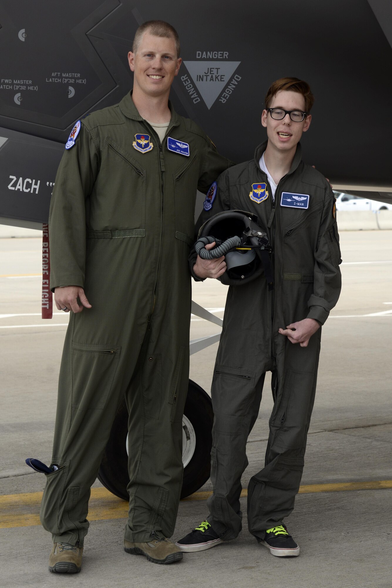 Capt. Joseph Walker, 62nd Fighter Squadron flight commander, and Zack "Z-man" Anderson, 16, pose with the F-35 Lightning II at Luke Air Force Base, Ariz., April 7, 2016. Anderson received the tour as part of the pilot for a day program, which provides children who have serious or chronic illnesses an opportunity to be part of a flying squadron for an entire day. (U.S. Air Force photo by Senior Airman Devante Williams)