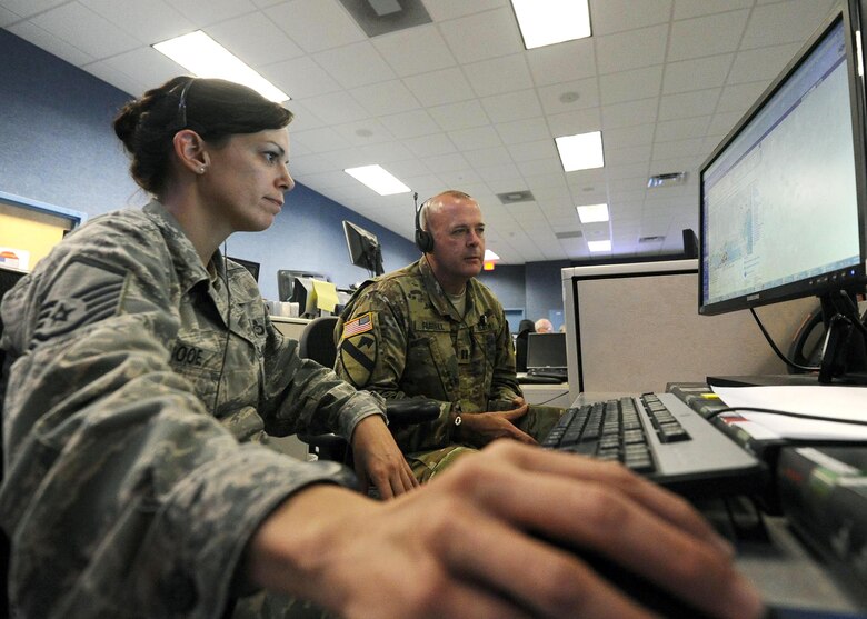Master Sgt. Tabitha Booe, 601st Air Operations Center weather support team NCO in-charge, and Army Capt. Kevin Farrell, 601st AOC air defense operations task force archangel officer, monitors the weather across the continental United States April 5, at the 601st AOC. The 601st Air Operations Center plans, directs, and assesses air and space operations for the North American Aerospace Defense Command and U.S. Northern Command. (U.S. Air Force photo by Senior Airman Ty-Rico Lea/Released)