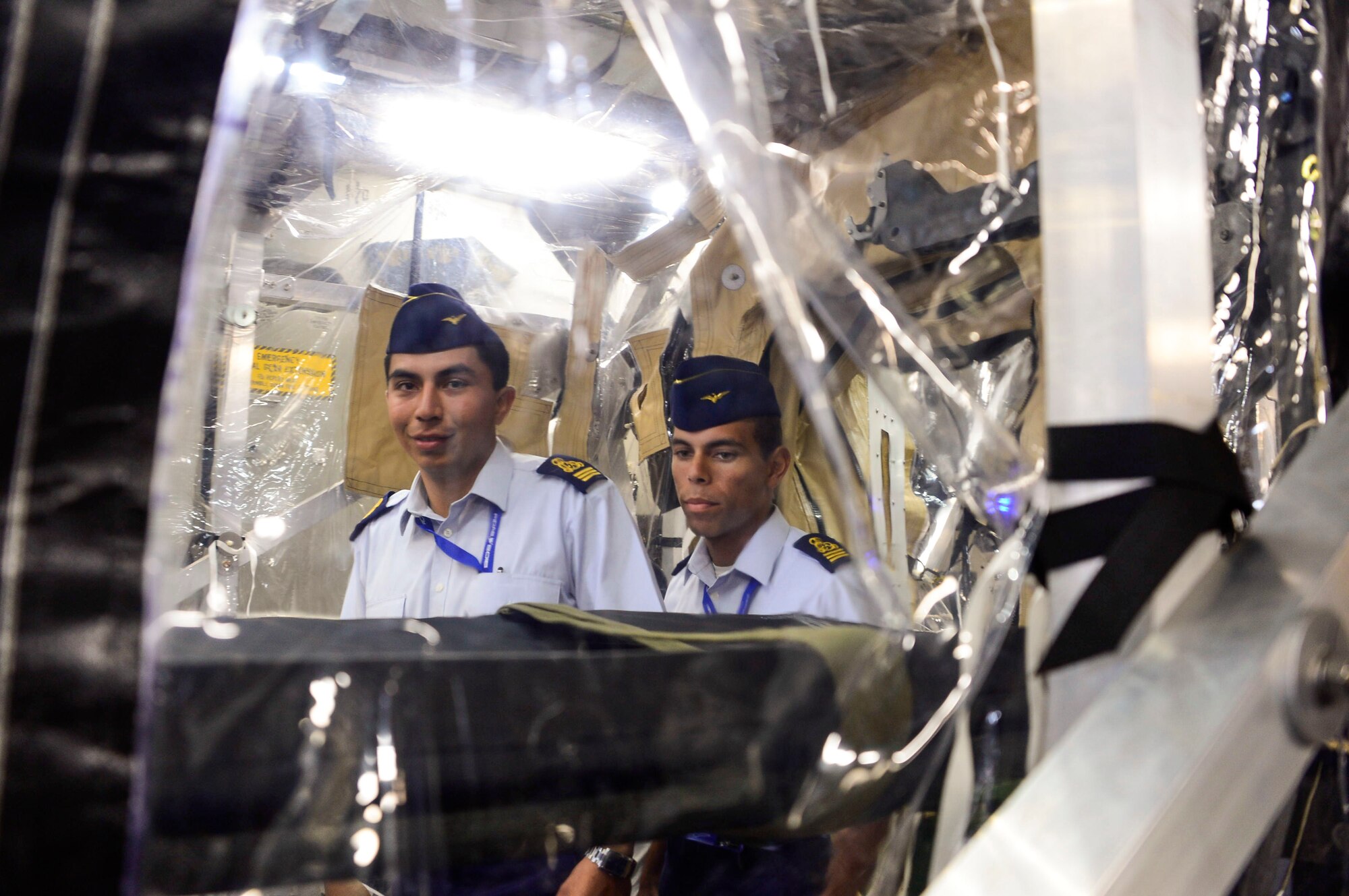 Airmen from the Chilean Air Force take a tour of the Transport Isolation System during the 2016 International Air and Space Fair (FIDAE) in Santiago, Chile, March 30, 2016. Exchanges are conducted regularly throughout the year and involve U.S. Airmen sharing best practices and procedures to build partnerships and promote interoperability with partner-nation air forces throughout South America, Central America and the Caribbean.  (U.S. Air Force photo by Tech. Sgt. Heather Redman/Released)