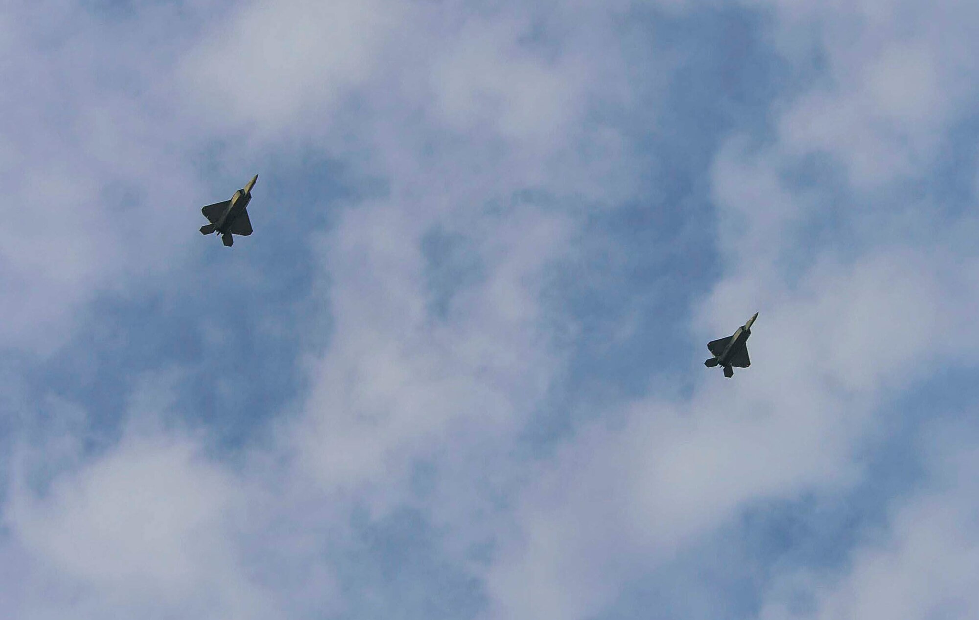Two F-22 Raptors, from the F-22 Demonstration Team at Langley AFB, Va., fly into Santiago, Chile, to participate in 2016 International Air and Space Fair (FIDAE), on March 27, 2016.  Airmen from around the U.S. are scheduled to participate in a variety of activities during the week-long air show that includes aerial demonstrations, interaction with the local community, and subject matter expert exchanges with the Chilean air force. (U.S. Air Force photo by Tech. Sgt. Heather Redman/Released)