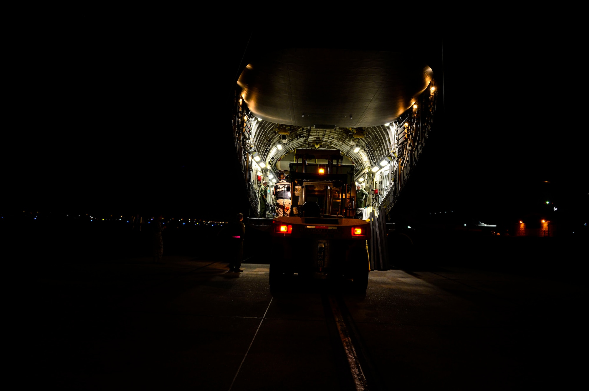 U.S. Airmen, from Wright-Patterson AFB, Ohio, work with Chilean airmen to unload a C-17 Globemaster III in Santiago, Chile, for the 2016 International Air and Space Fair (FIDAE), March 27, 2016.  Airmen from around the U.S. are scheduled to participate in a variety of activities during the week-long air show that includes aerial demonstrations, interaction with the local community, and subject matter expert exchanges with the Chilean air force. (U.S. Air Force photo by Tech. Sgt. Heather Redman/Released)