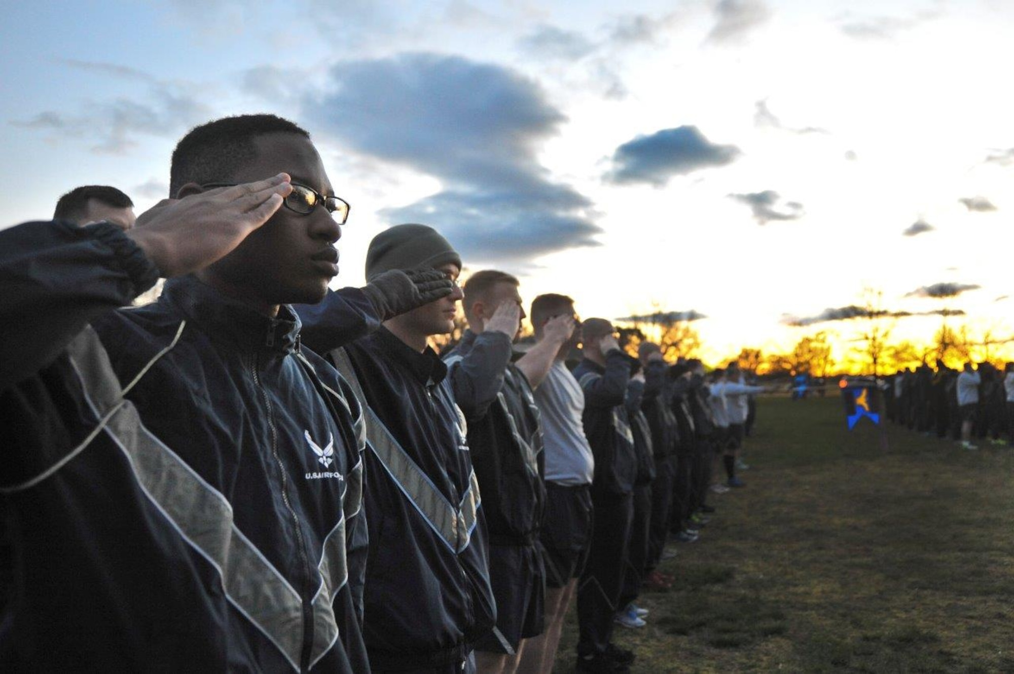 Airmen assigned to the 70th Intelligence, Surveillance and Reconnaissance Wing render a salute as revile is played before beginning the 2016 Sexual Assault, Awareness and Prevention Month garrison run April 8, 2016 at Fort George G. Meade, Md. There were over 1,900 joint service members participating in the SAAPM event. (U.S. Air Force photo/Staff Sgt. Alexandre Montes)