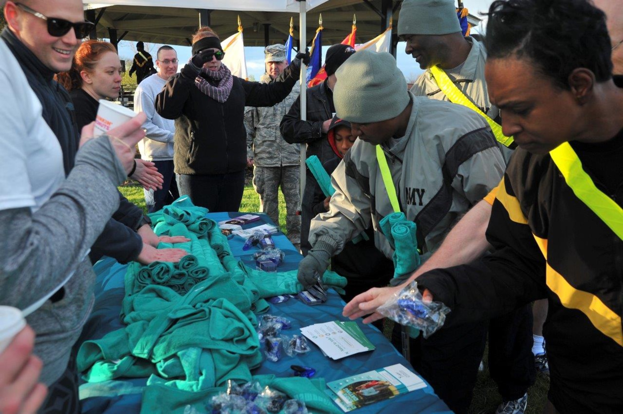70th Intelligence, Surveillance and Reconnaissance Wing Sexual Assault Prevention and Response office, Volunteer Victim Advocates, and Sexual Harassment/Assault Response and Prevention office member pass out informational gifts after the 2016 Sexual Assault, Awareness and Prevention Month garrison run April 8, 2016 at Fort George G. Meade, Md. There were over 1,900 joint service members participating in the SAAPM event. (U.S. Air Force photo/Staff Sgt. Alexandre Montes)