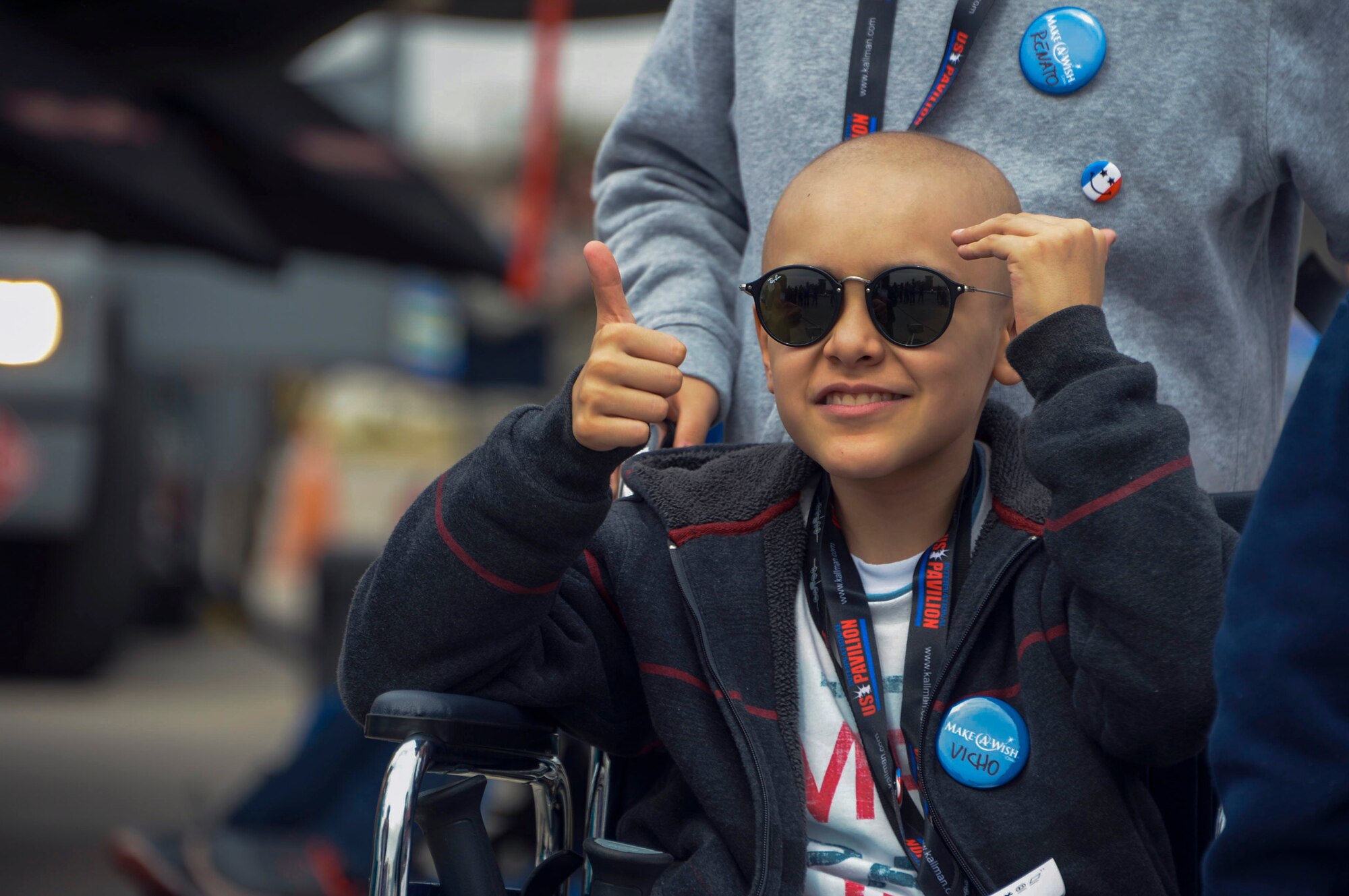 A young boy gives a thumbs-up after visiting the F-22 Raptor static display at the 2016 International Air and Space Fair (FIDAE) in Santiago, Chile, April 1, 2016. Airmen from around the U.S. came to Chile to participate in FIDAE 2016, from March 29– April 3.  During their stay, they made time to connect one-on-one with members of the community and hosted children from the Make-A-Wish and Teletón Foundations. (U.S. Air Force photo by Tech. Sgt. Heather Redman/Released)